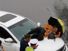 摩托车与小车发生擦挂 司机爬上小车引擎盖睡着